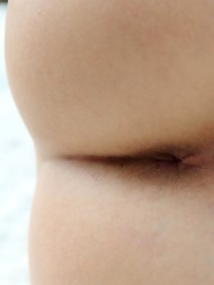 Assoli playfully lifts the hem of her dress, revealing her shapely thighs and a gorgeous, meaty pussy